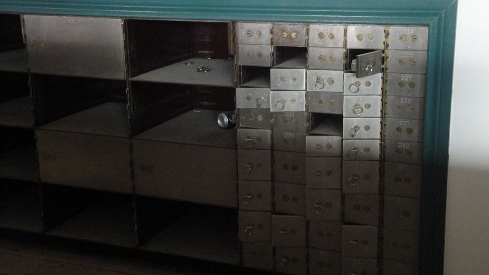 Rows of numbered safe-deposit boxes along a vault wall
