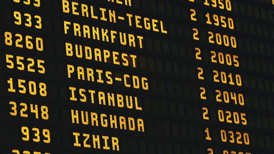 Split-flap departures board listing destinations and times