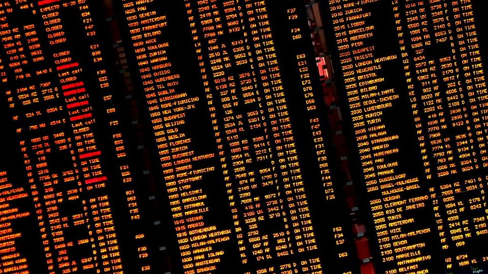 Dense amber display board packed with rows of codes and times