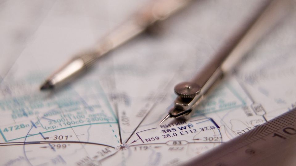 Navigation dividers resting on a nautical chart