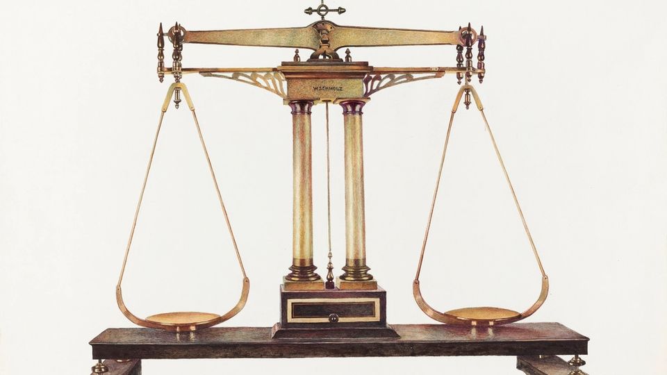 Antique brass balance scale on a white background