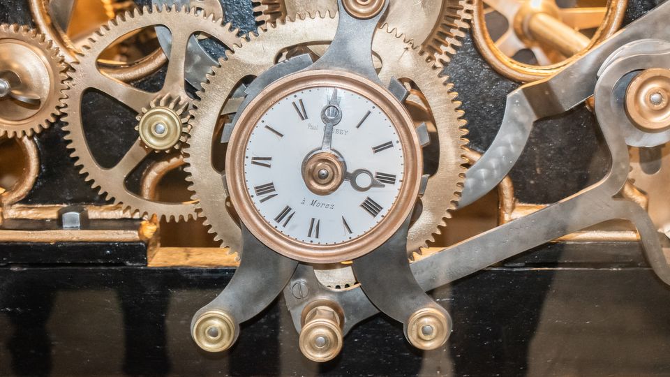 Brass gears and wheels inside a large clock mechanism