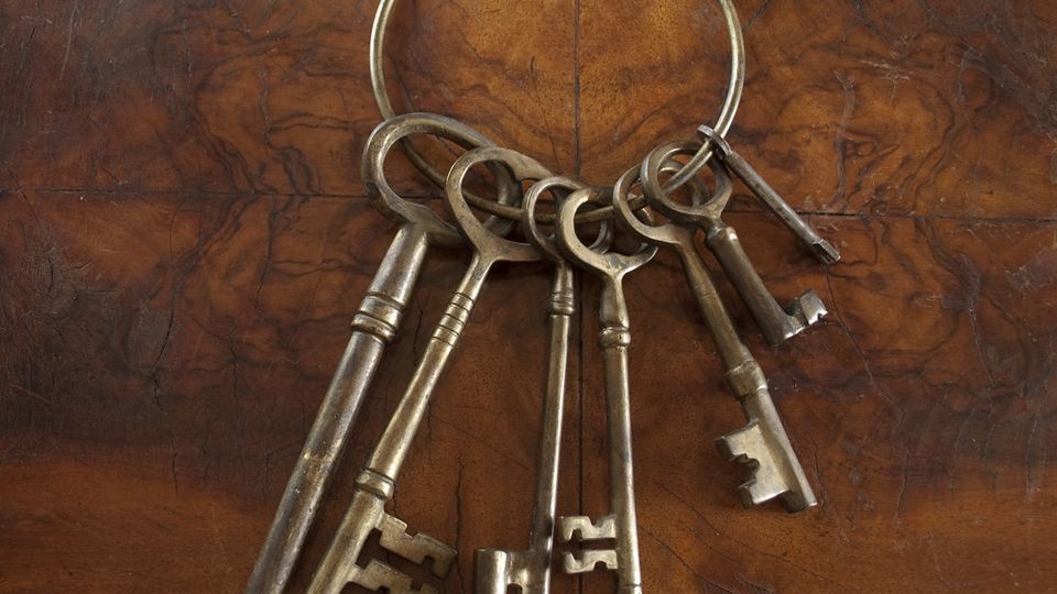 Ring of old iron skeleton keys on a wooden table