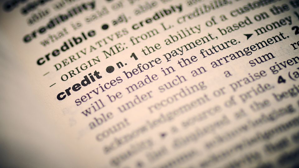 Close-up of a dictionary page with the entry for credit
