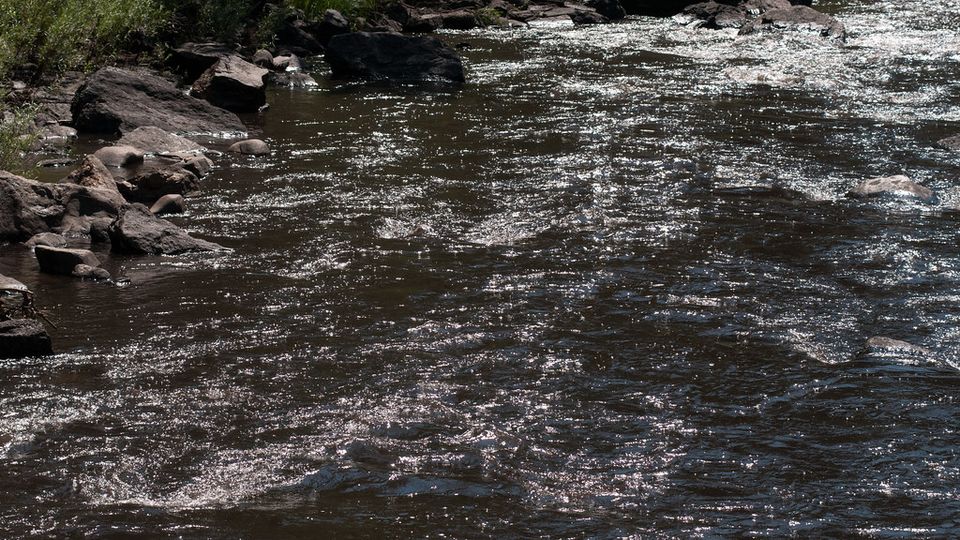 Fast-flowing river water rushing over rocks