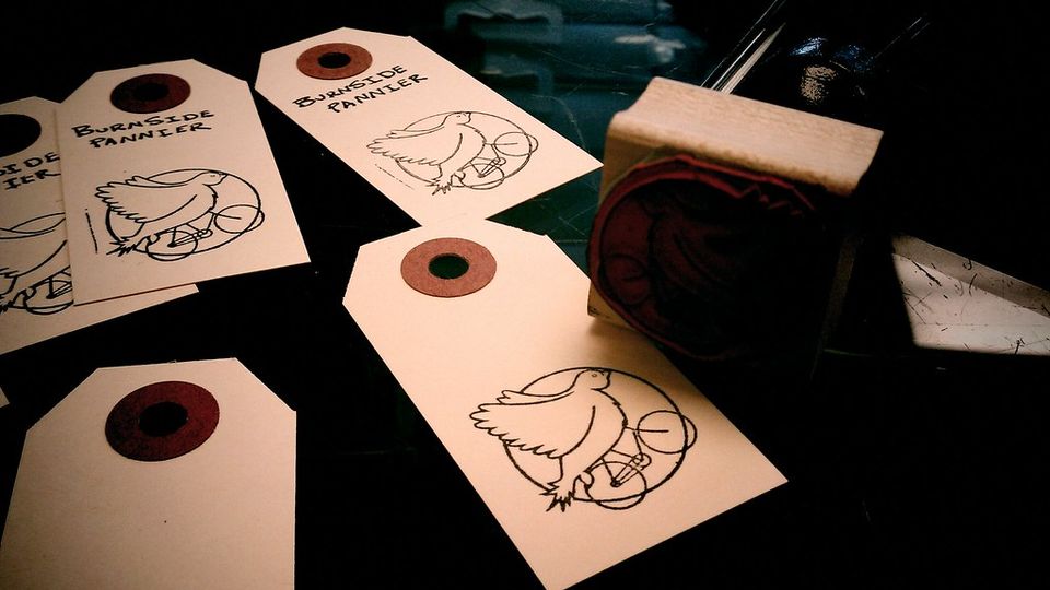 Blank brown price tags with strings on a dark surface