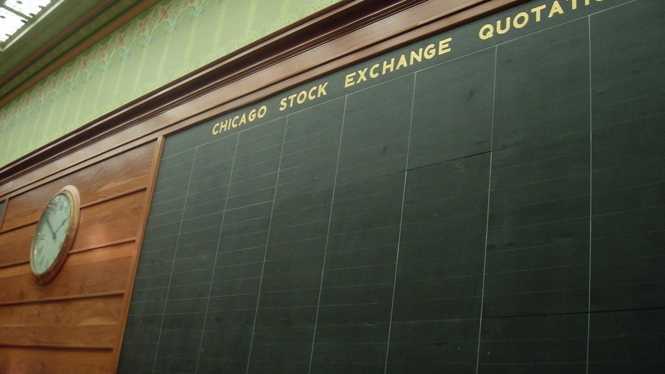 Historic stock exchange quotations board on a panelled wall