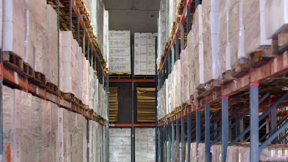 Tall warehouse shelving stacked with boxes