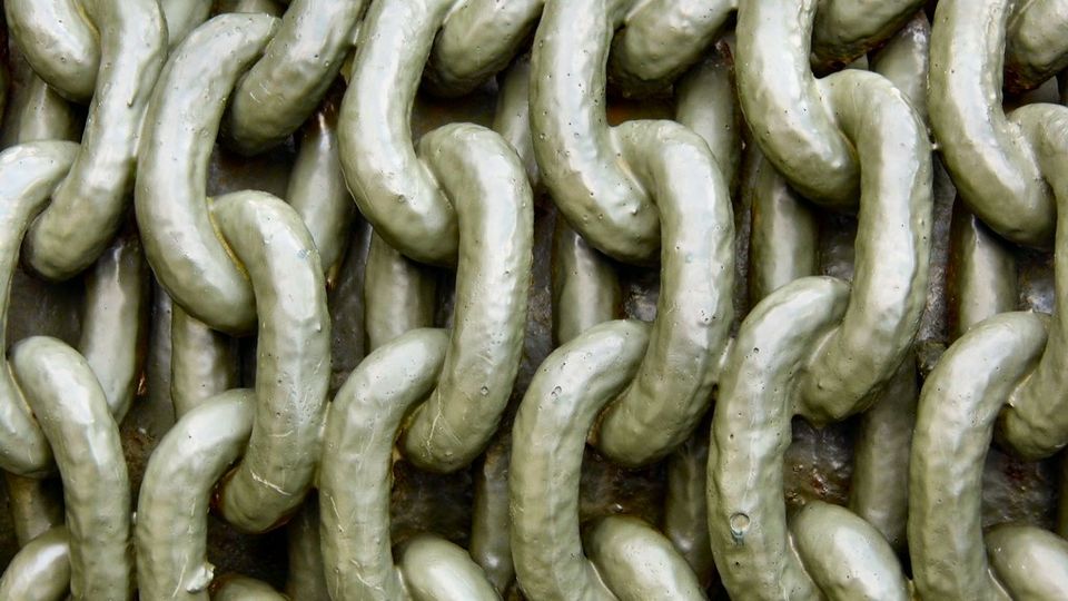 Tightly packed links of heavy metal chain