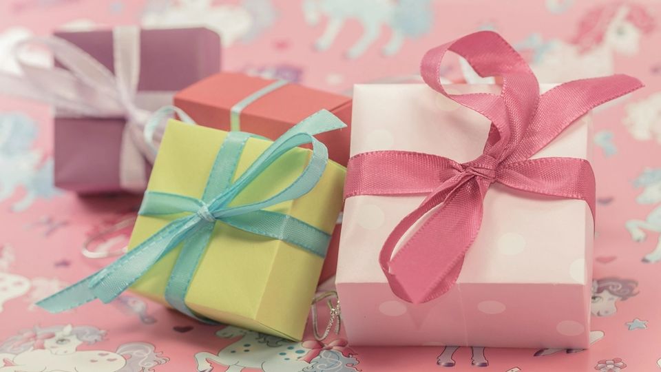 Small gift boxes wrapped in coloured paper and ribbons